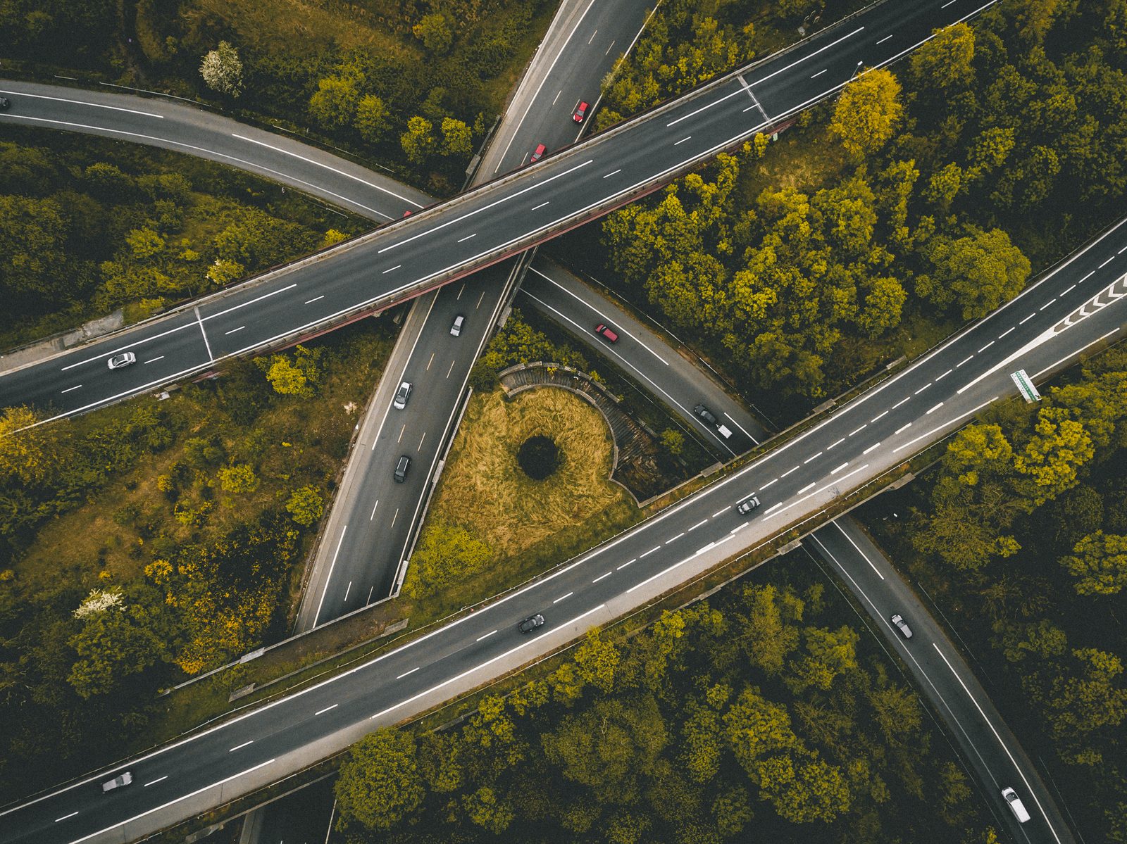 Aerial view of multi-lane transportation interchange with moving traffic
